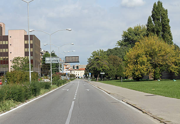 istock paved road throughout the day without car pollution 184795279