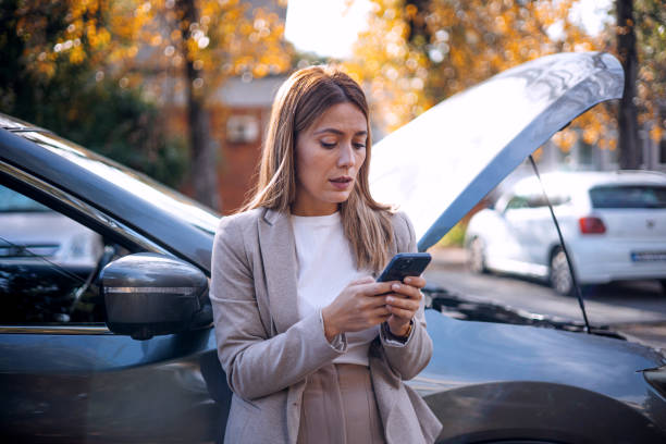 istock Woman with flat tire calls for help 1847970758