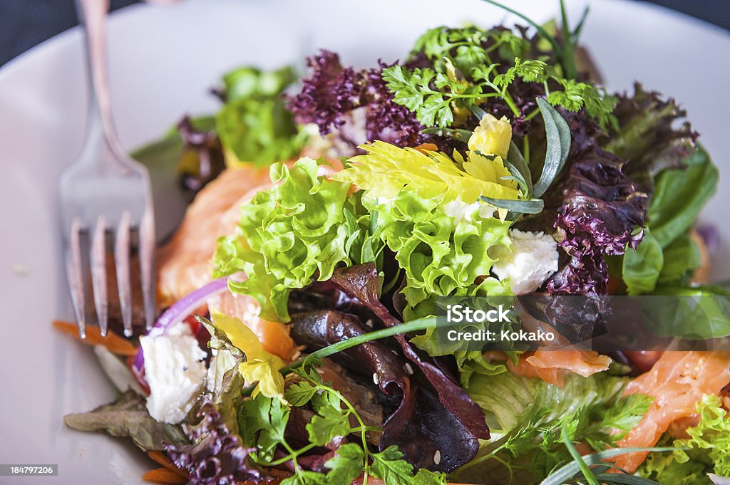 Green salald Green salad on white plate with fork Cafe Stock Photo