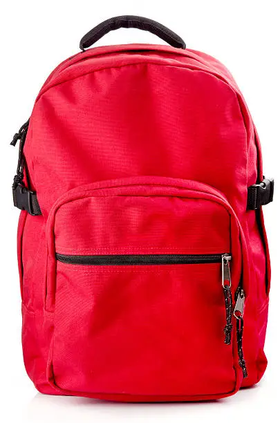 Red backpack standing isolated on white background