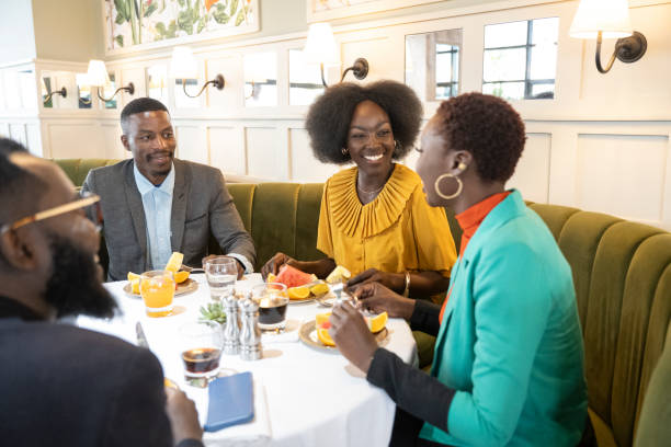African office workers eating meal together in restaurant