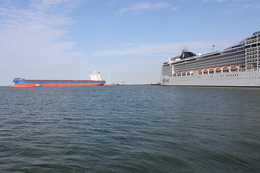 Trucks on ferry floats by English Channel on a sunny day