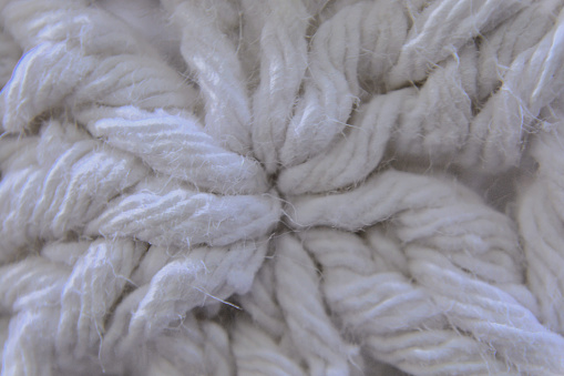 The beautiful crochet stitches of the raw cotton cord rug in the yard