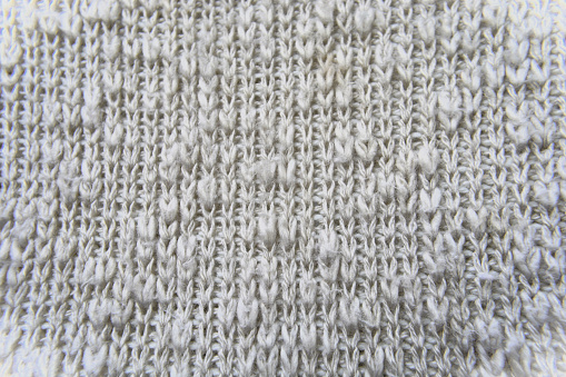 Details of the knitting stitches of the hanging beige blouse