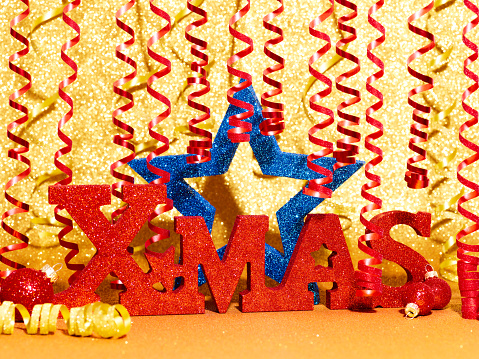 Gold color Christmas and New Year 2024 holiday background with red Xmas label and blue star