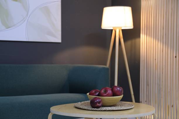 istock Red apples on side table near sofa in living room. Space for text 1848017109