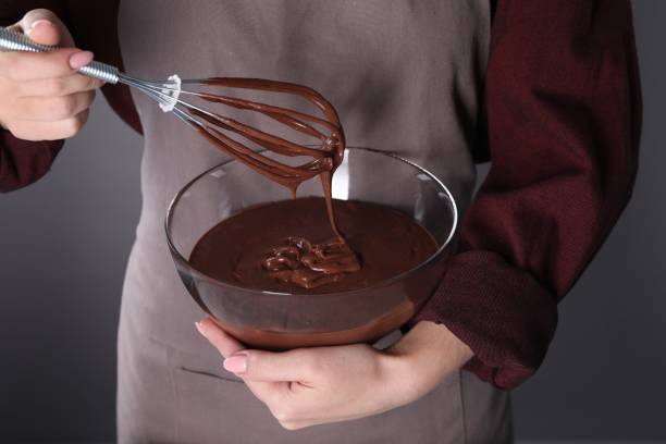 istock Woman with whisk making chocolate cream on grey background, closeup 1848029792