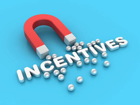 Magnet with Spheres and Incentives Word - Color Background - 3D Rendering