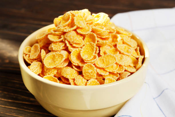 istock Healthy breakfast. Cornflakes in a bowl on a wooden table. Place for text. Top view. 1848041049