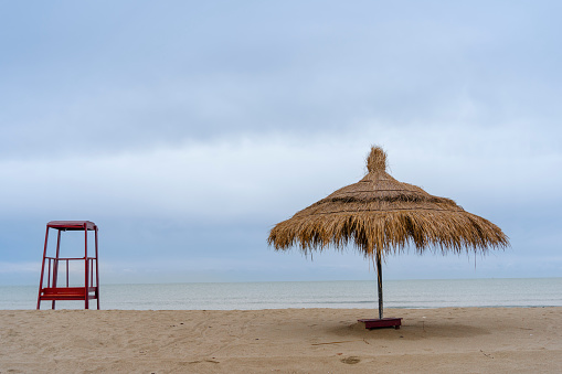 Adriatic sea, Albania coast beautiful sky ,  Lifeguard tower Straw umbrella  Lalzi Bay (Gjiri i Lalzit)