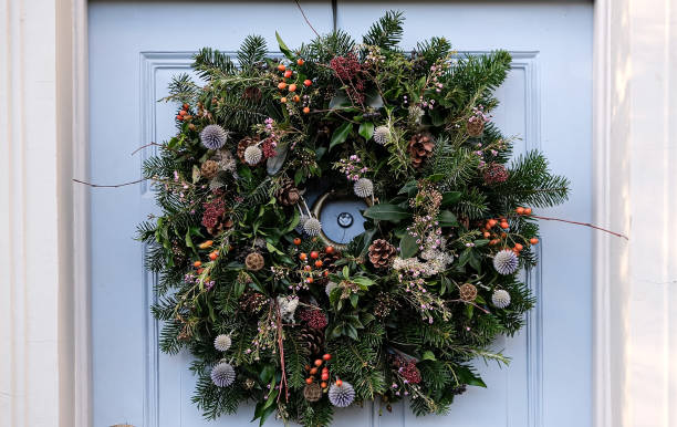 istock Christmas wreath on a light grey blue wooden door 1848055376