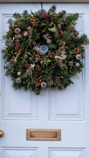 istock Christmas wreath on a light grey blue wooden door 1848055802