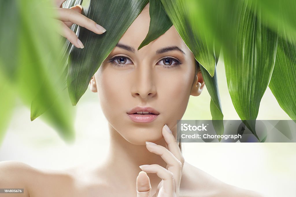 healthy face beautiful girl and green leaves Women Stock Photo