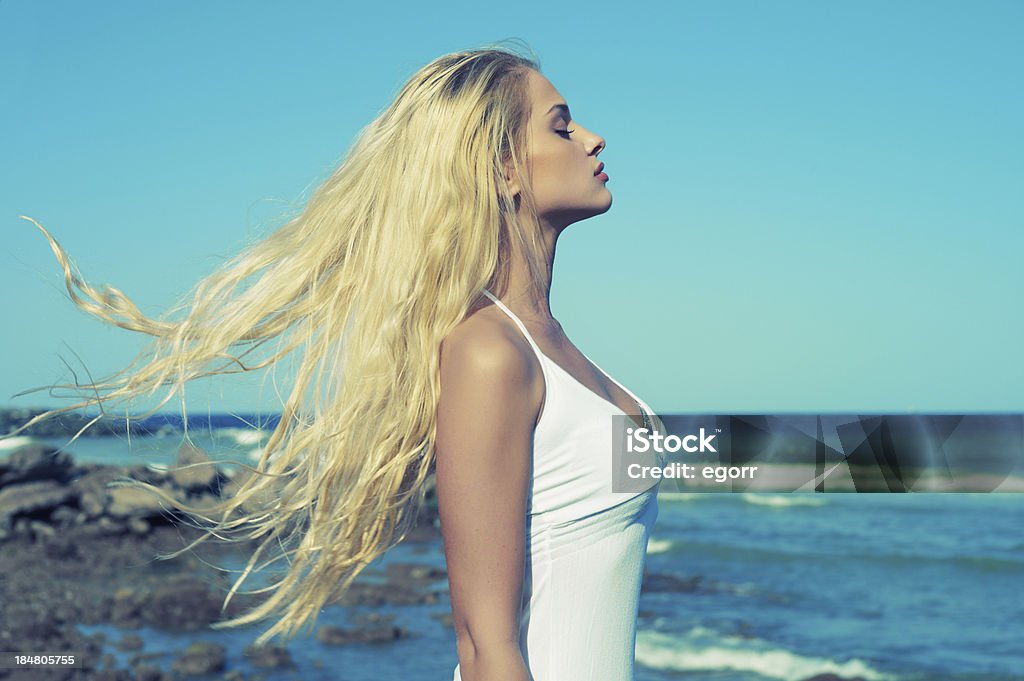Beautiful woman at sea Photo of beautiful young blonde at blue sea Women Stock Photo