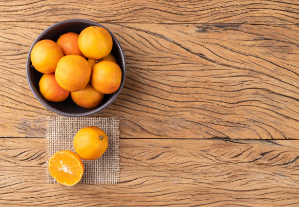 istock Cravo or rose lemons in a bowl over wooden table with copy space 1848073608
