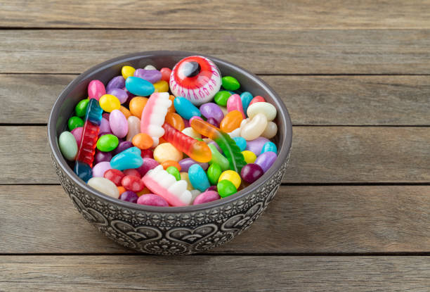 istock Assorted colorful candies on a bowl over wooden table 1848073757