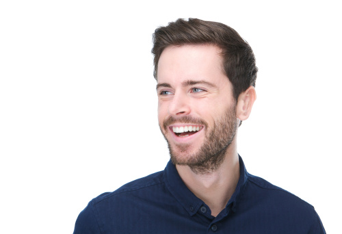 Close up portrait of a handsome young man smiling on isolated white background