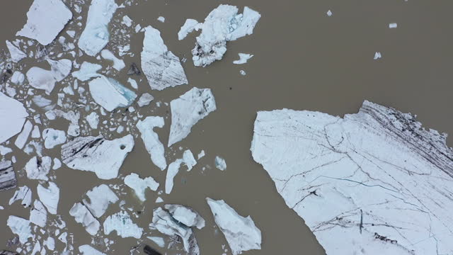 Aerial view of rapid melting glaciers and icebergs in Greenland due climate change and global warming