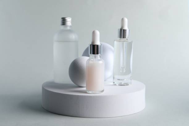 istock Stylish presentation of bottles with cosmetic serums on light grey background 1848090363