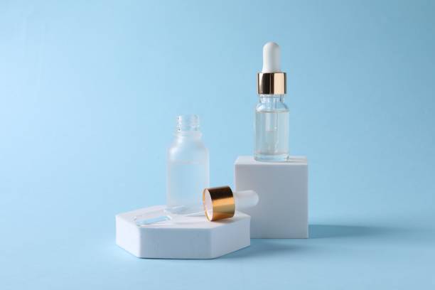 istock Presentation of bottles with cosmetic serums on light blue background 1848091373