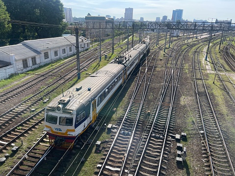 Kyiv, Kyiv Oblast, UKRAINE - July 19, 2023: Central Kyiv Summer Day, Locomotive and Cars on Train Tracks