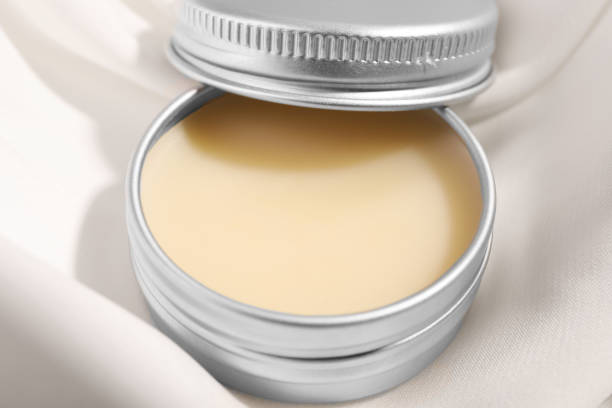 istock Lip balm on white fabric, closeup view 1848094208