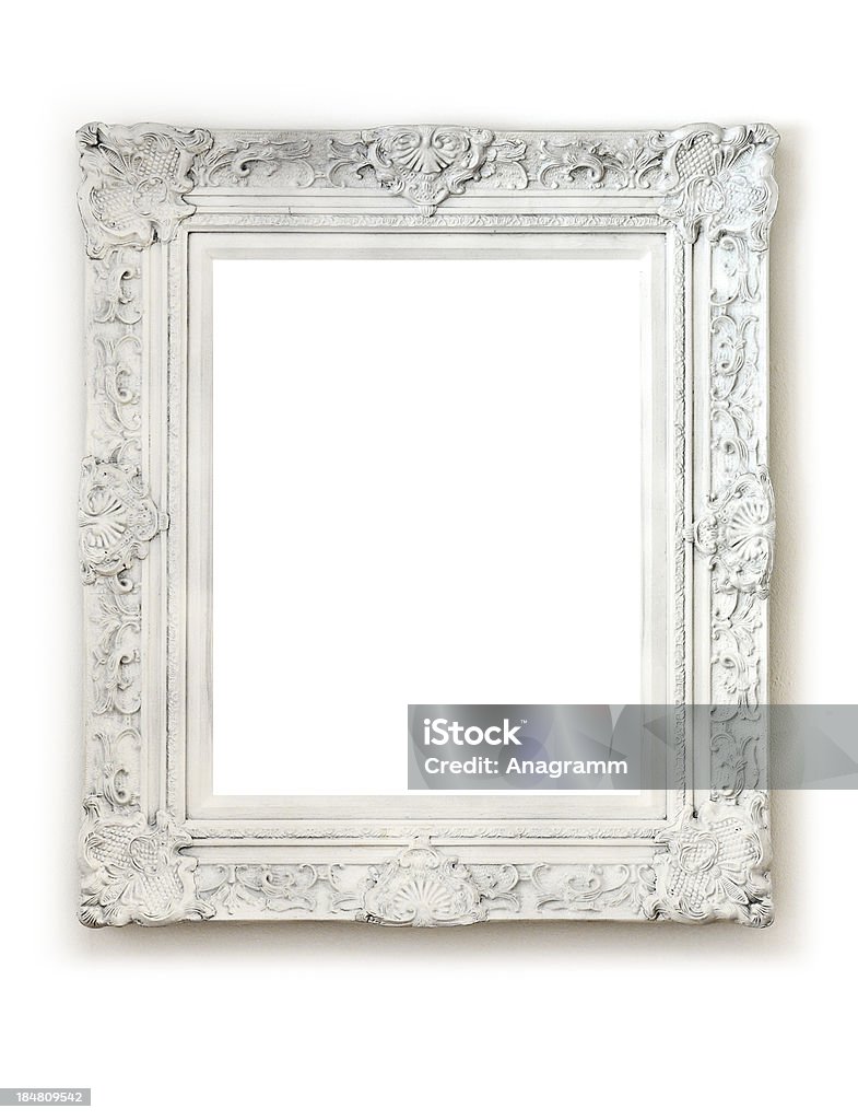 Vintage empty frame on white wall Vintage empty frame isolated on white wall. Picture Frame Stock Photo