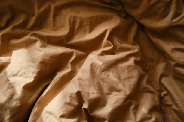istock Top view of sheets and pillows. Brown linens. Bed texture 1848105689