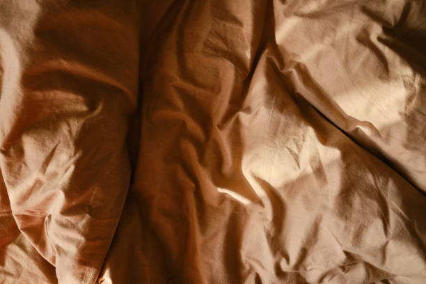 istock Top view of sheets and pillows. Brown linens. Bed texture 1848105690
