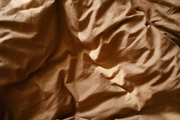 istock Top view of sheets and pillows. Brown linens. Bed texture 1848105692