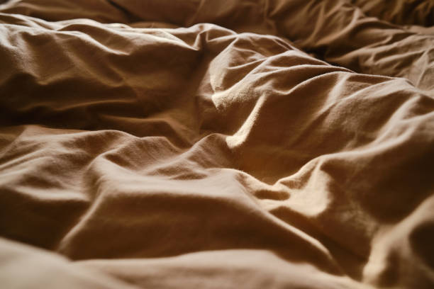 istock Top view of sheets and pillows. Brown linens. Bed texture 1848105695