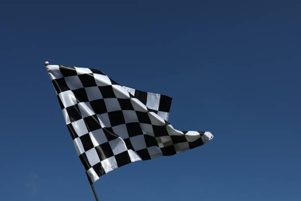 istock One checkered flag against blue sky outdoors, low angle view and space for text 1848107789