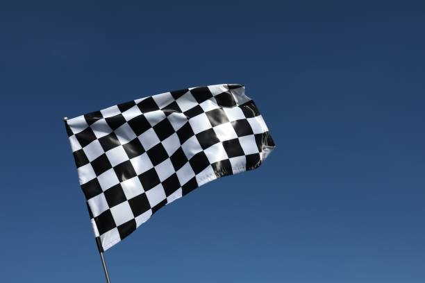 istock One checkered flag against blue sky outdoors, low angle view and space for text 1848107792