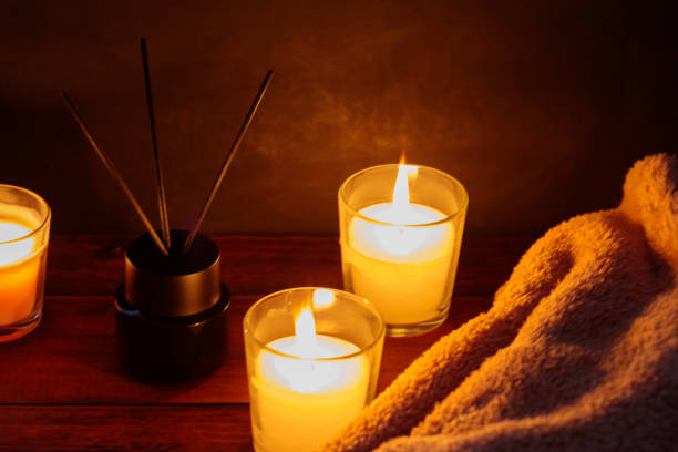 istock Soothing Aromatherapy with Reed Diffuser, Blanket and Candles on Wooden Table 1848114130
