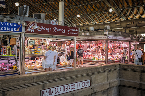 Meat stalls and shoppers inside the Mercado de Asbastos in Alicante, Spain on 29 August 2023
