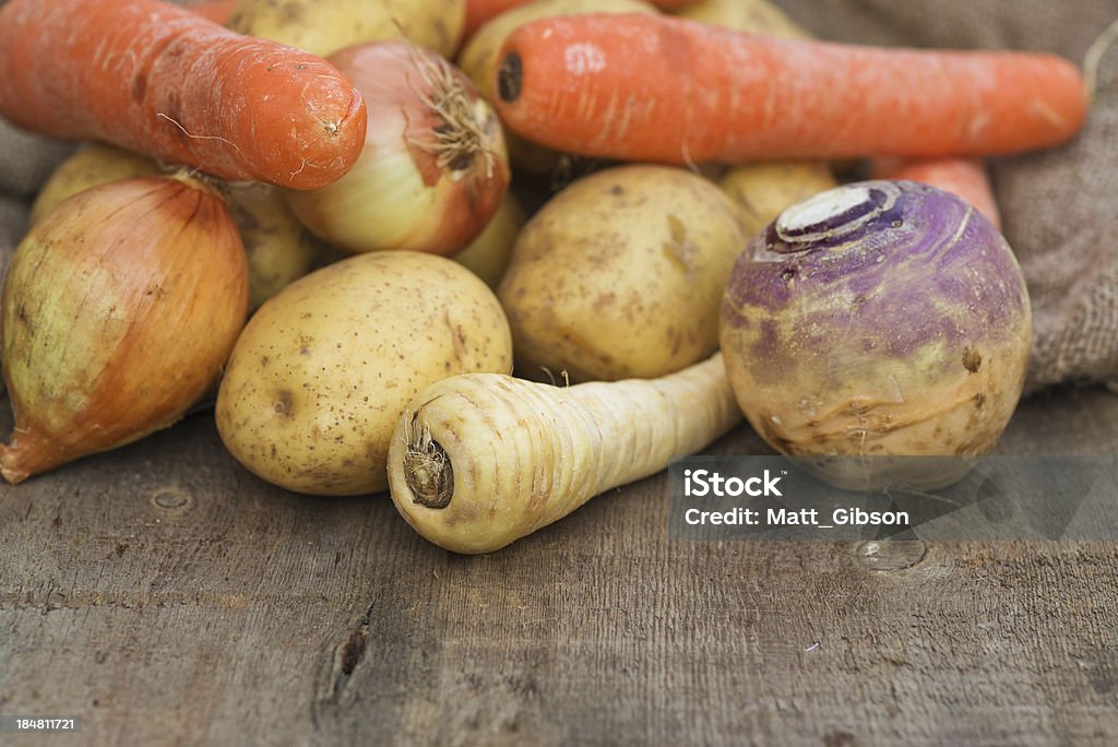 Winter seasonal vegetables including potatoes parsnips swede and carrots Collection of Autumn and Winter seasonal vegetables for stews and broths Raw Potato Stock Photo