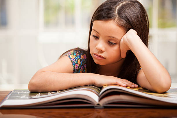 istock Little girl focused on reading 184811917