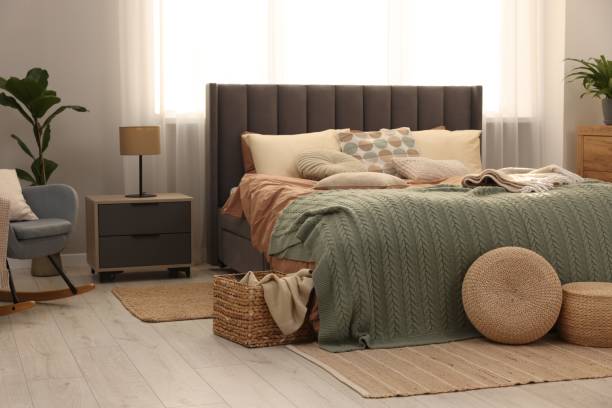istock Large comfortable bed with soft pillows and blanket in room. Home textile 1848124958