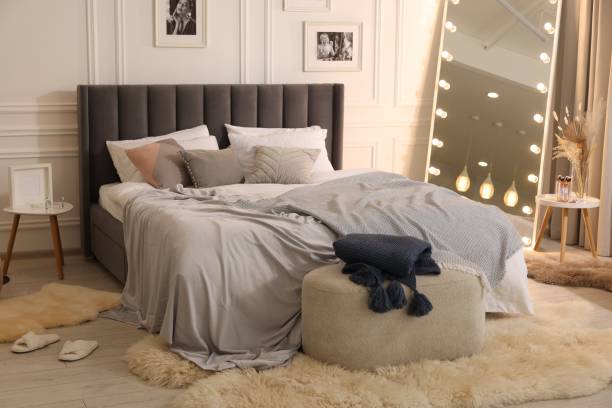 istock Large comfortable bed with soft pillows and blanket in room. Home textile 1848125475