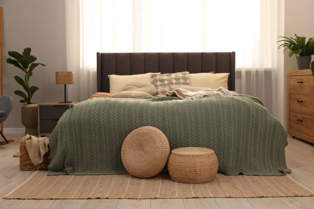 istock Large comfortable bed with soft pillows and blanket in room. Home textile 1848126002