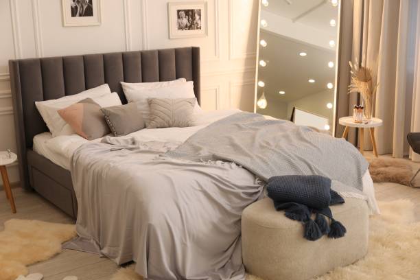 istock Large comfortable bed with soft pillows and blanket in room. Home textile 1848126007
