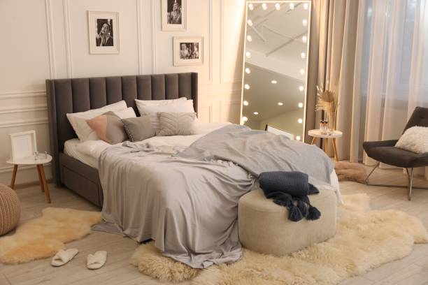 istock Large comfortable bed with soft pillows and blanket in room. Home textile 1848126010