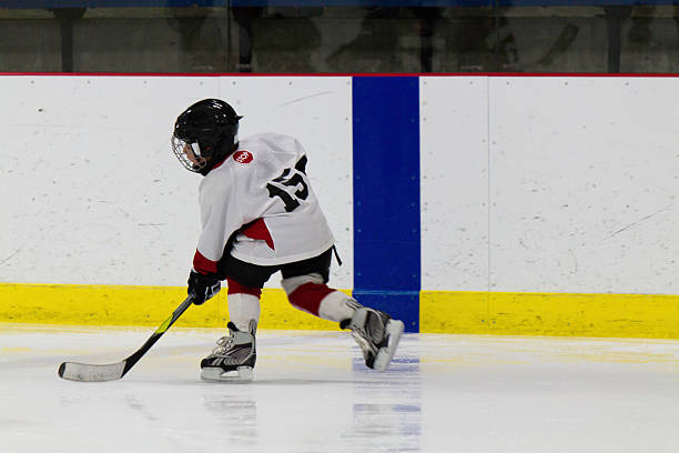 Child playing ice hockey stock photo
