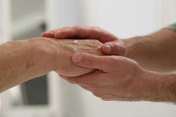 istock Trust and support. Men joining hands indoors, closeup 1848152852