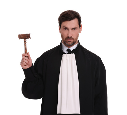 Judge in court dress with gavel on white background