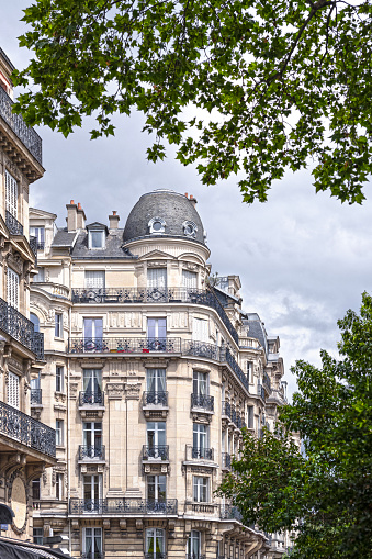 Paris, France : facade  of a typical building, The building is located 41 boulevard Raspail in Paris. The picture is taken in Babylone street.