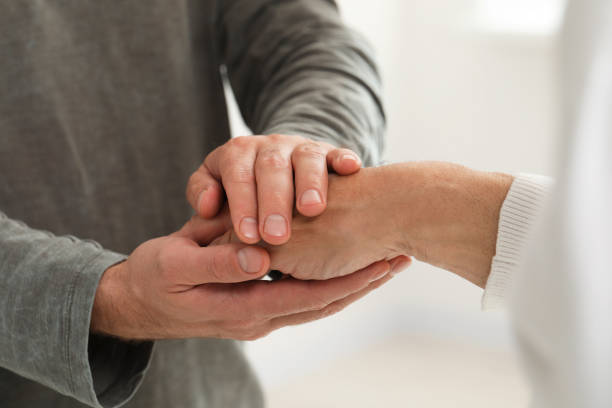 istock Trust and support. Men joining hands on blurred background, closeup 1848155530