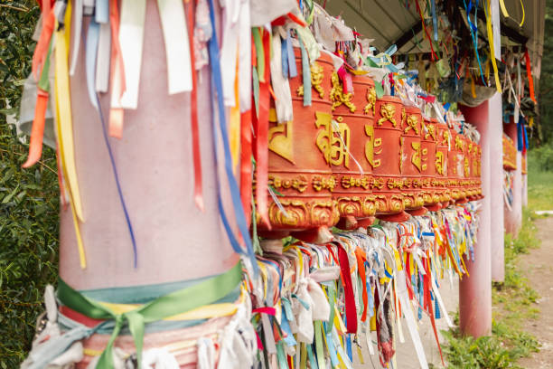 istock Rotating religious elements for touching turning spinning Buddhist prayer wheel at Buddhist monastery. Prayer wheels in Buddhist stupa temple. Buddhism religion concept. 1848160801