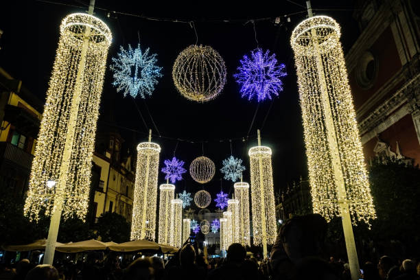 Elegant Holiday Light Columns and Snowflakes, Majestic columns of holiday lights and sparkling snowflakes dazzle in the night. in Seville, Spain.