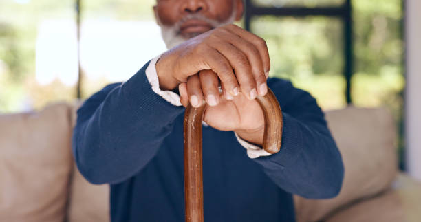 istock Walking stick, hands and elderly man with disability, stroke rehabilitation or homecare support in retirement. Closeup, senior and wood cane for balance of parkinson, arthritis or help for healthcare 1848219824